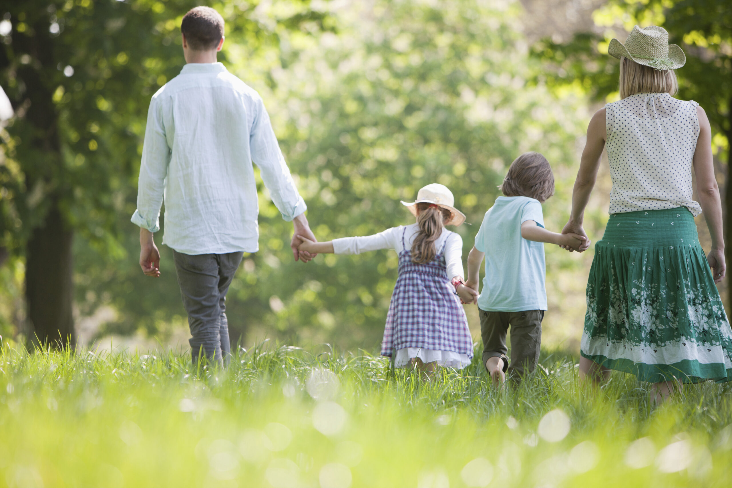 Family walking in field of flowers